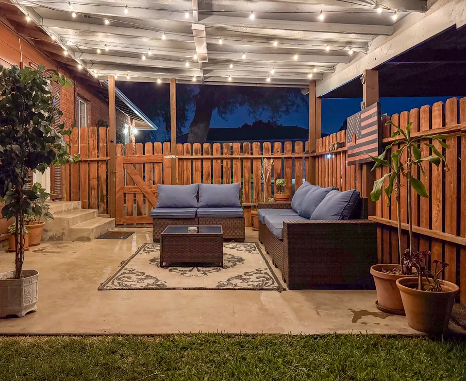 Covered patio with string lights and lounge seating