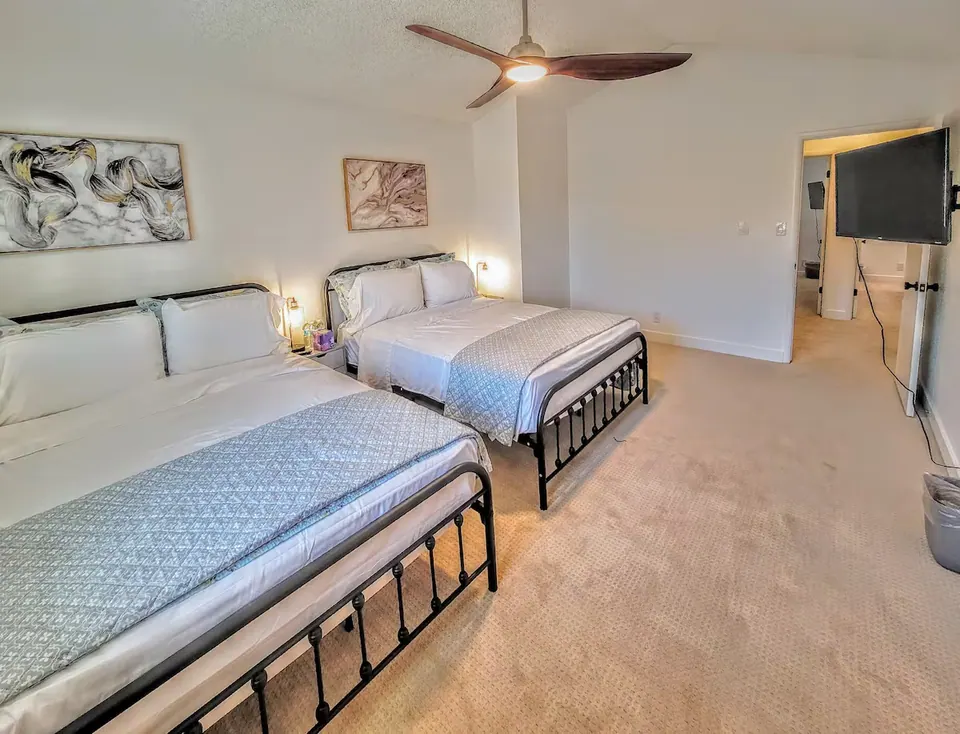 Bedroom with two beds and TV