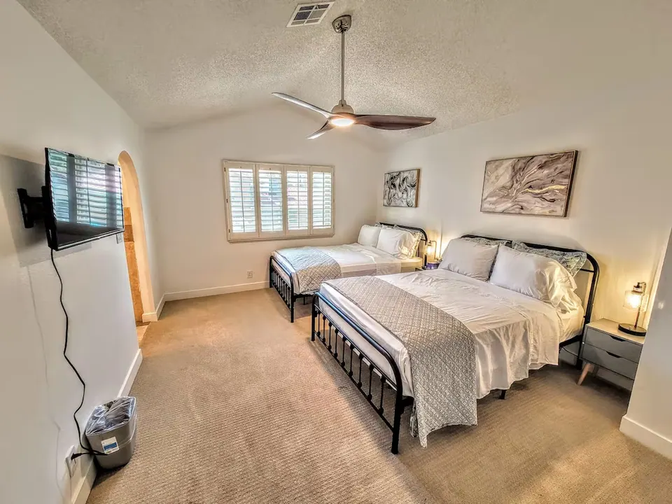 Bedroom with two beds and ceiling fan