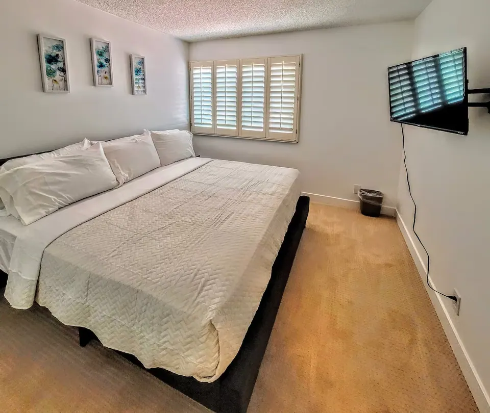 Bedroom with king bed and plantation shutters