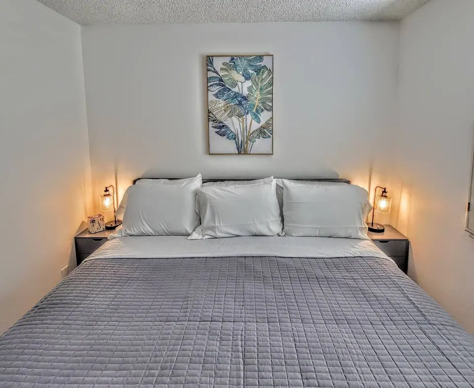 Bedroom with king bed and botanical art