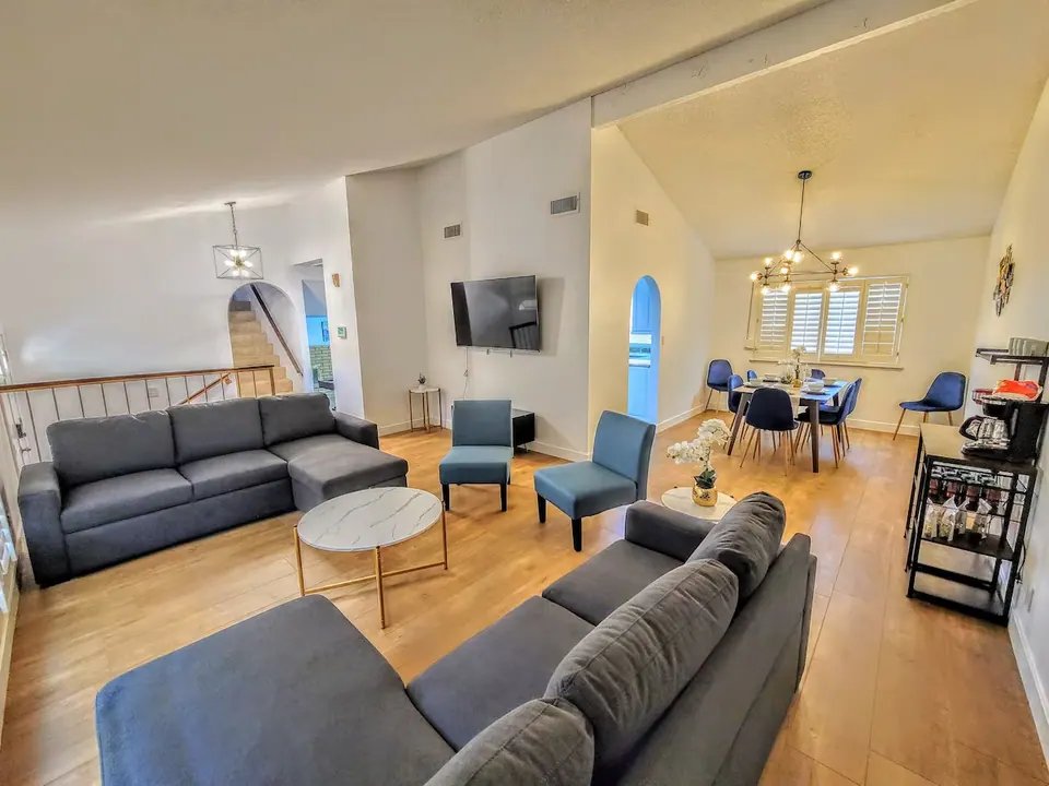 Open living room with sectional and dining area
