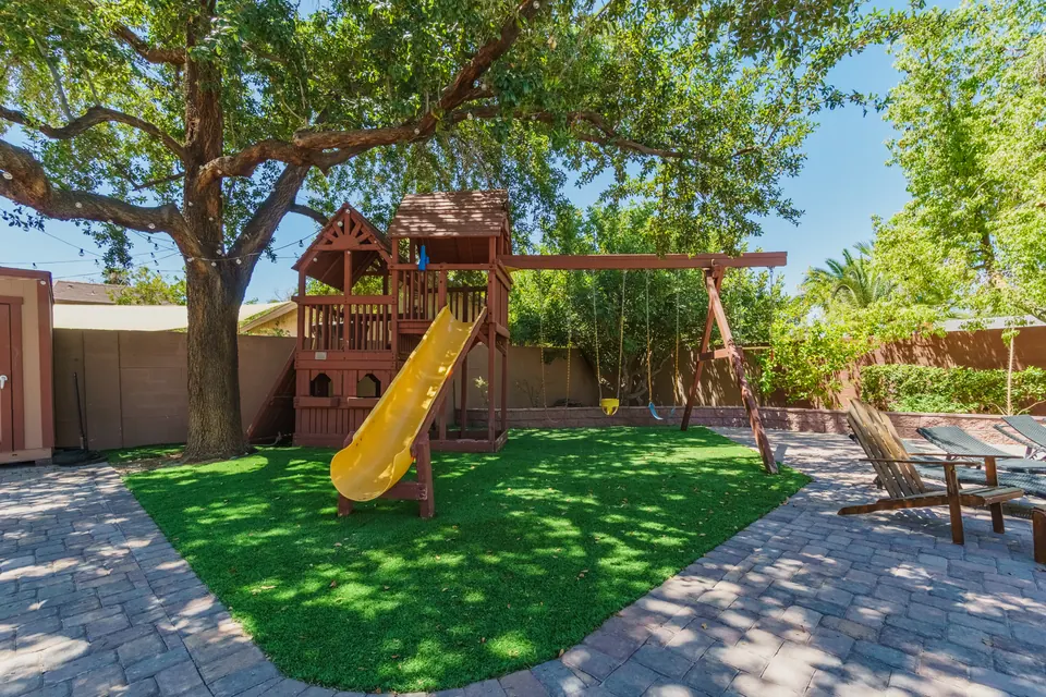 Kids’ play structure with slide on artificial turf