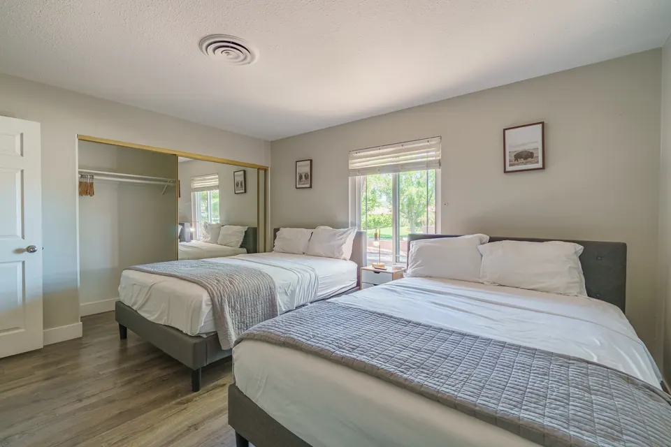 Bedroom 3 with two beds and mirrored closet
