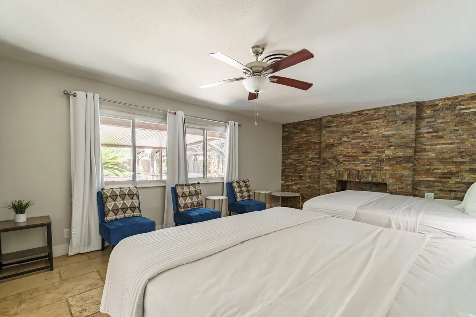 Bedroom 4 with stone accent wall and lounge chairs