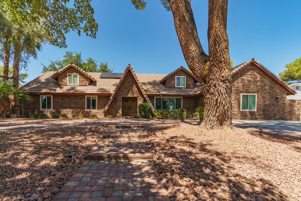 Front yard with U-shaped driveway and mature tree