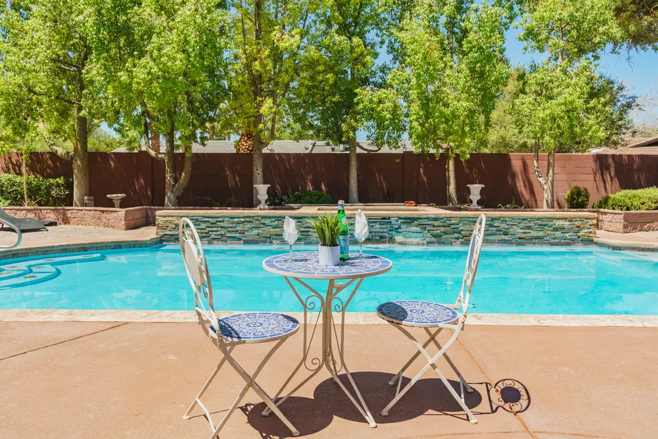 Poolside bistro table and stone water feature