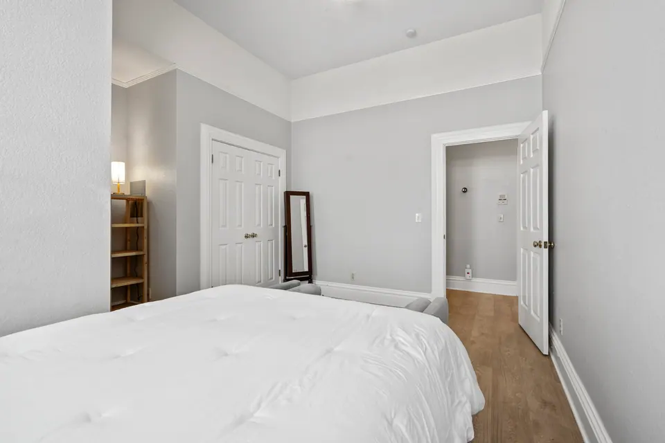 Bedroom with mirror and closet