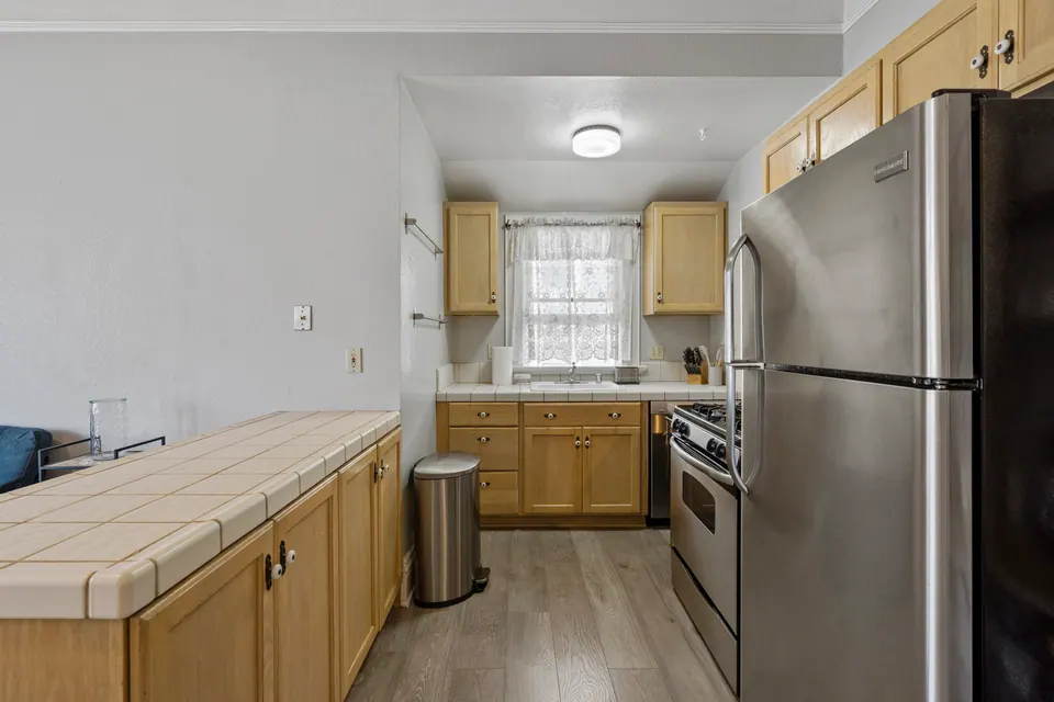 Kitchen with stainless fridge and gas range