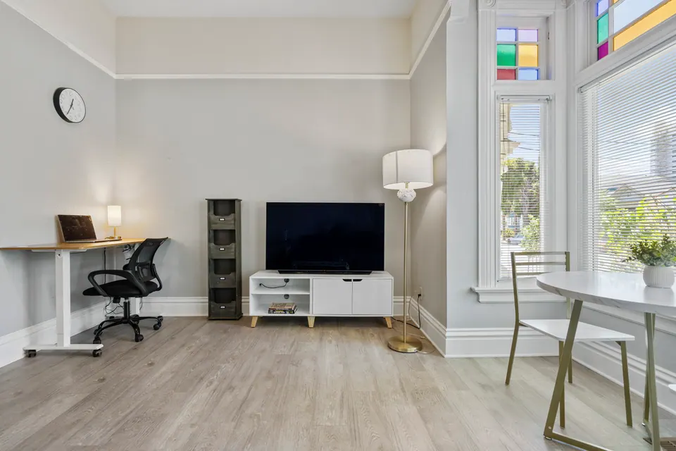 Living room with TV, desk and dining nook